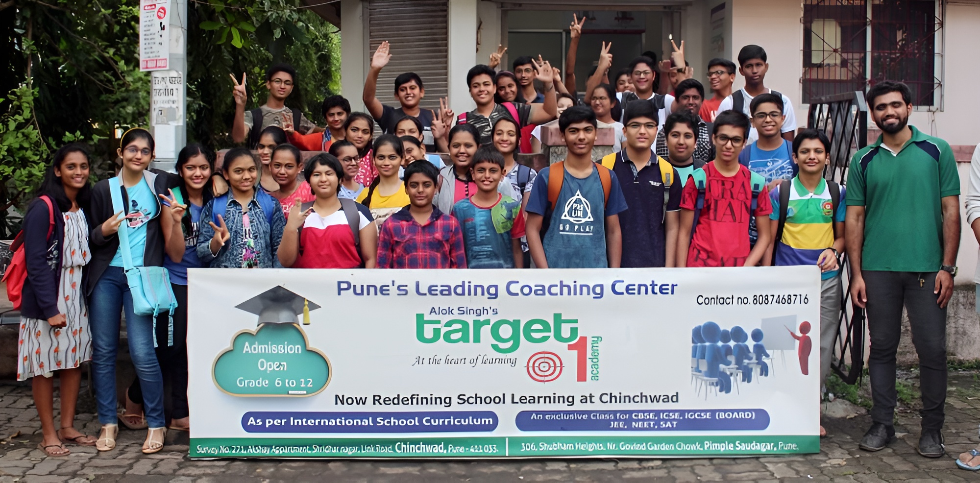 "Group of students and teachers at Pune's leading coaching center, Target 1, celebrating academic success."