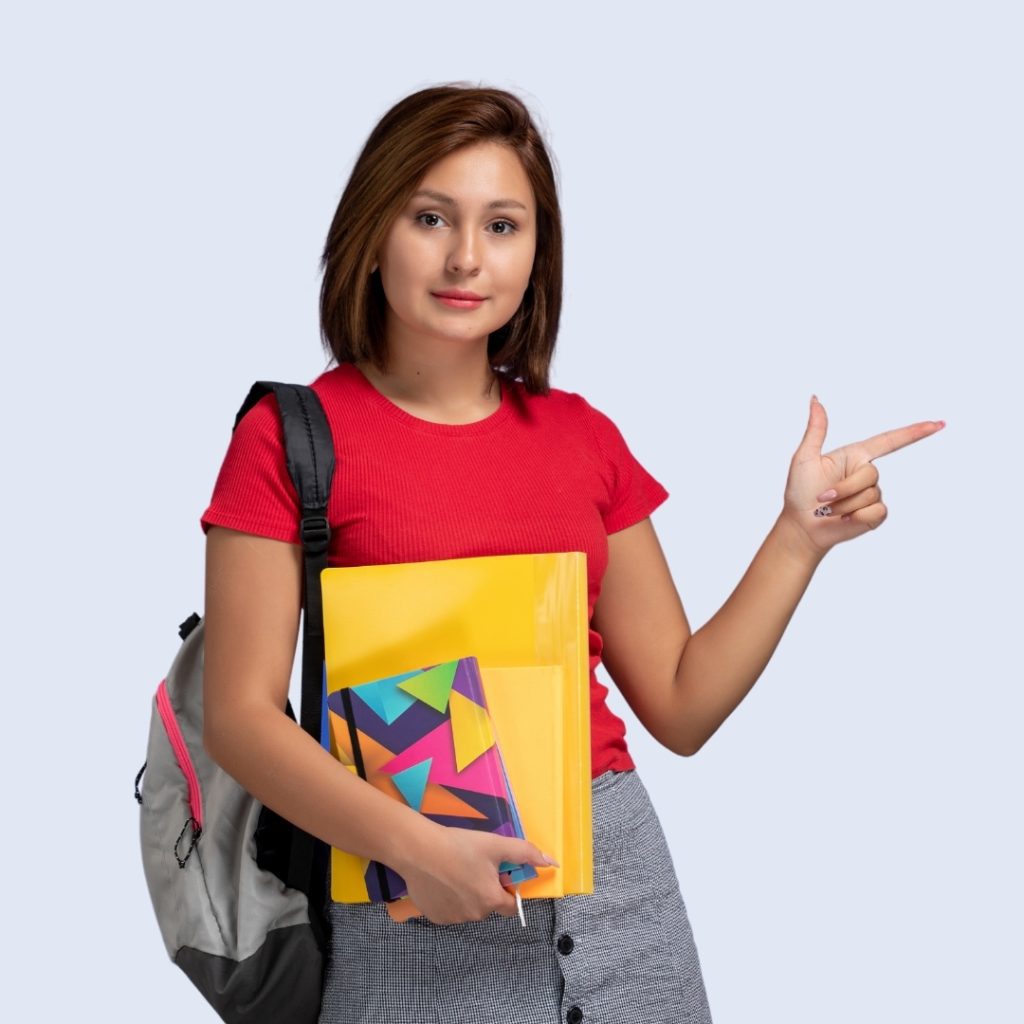 "A girl standing with books, ready for study."
