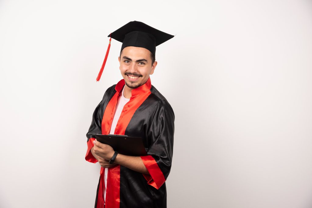 "A simple image of a graduated boy wearing a cap and gown."